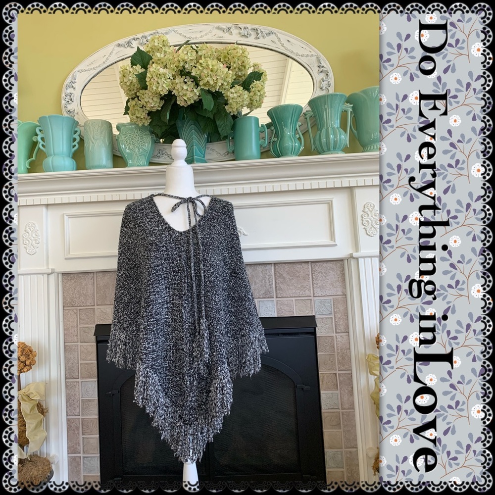 Sweater poncho with fringe and tassel tie
